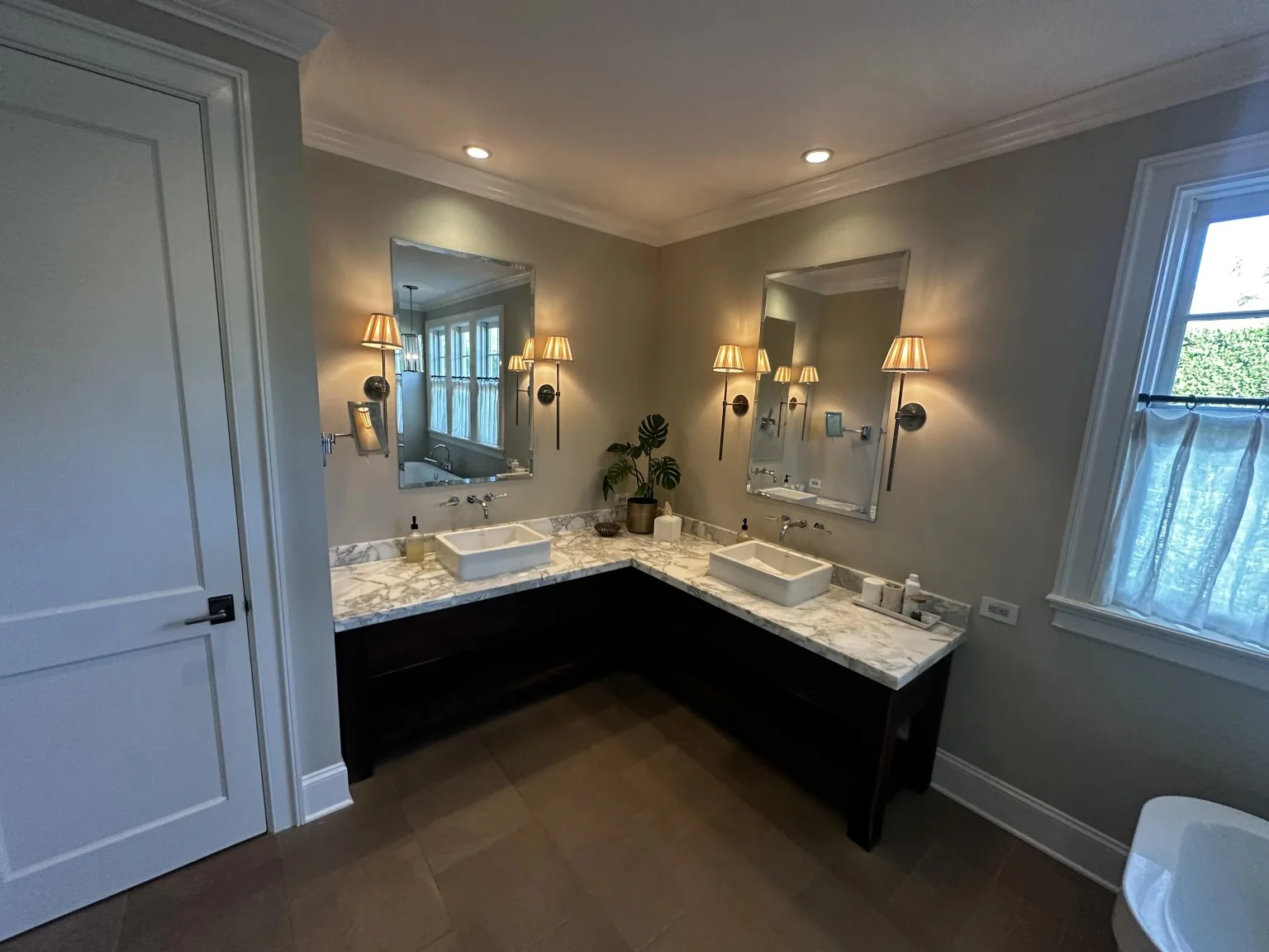 Custom bathroom vanity area with tile flooring and marble counter detail