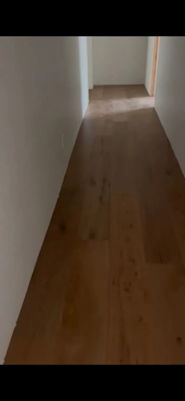 Wood-look hallway flooring installation in a residential home